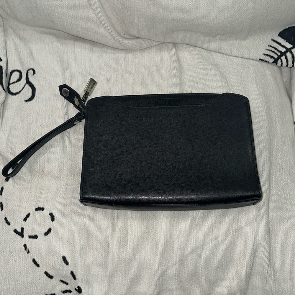 Moschino black and silver bag with 7.5” removable wrist strap sticky in pockets